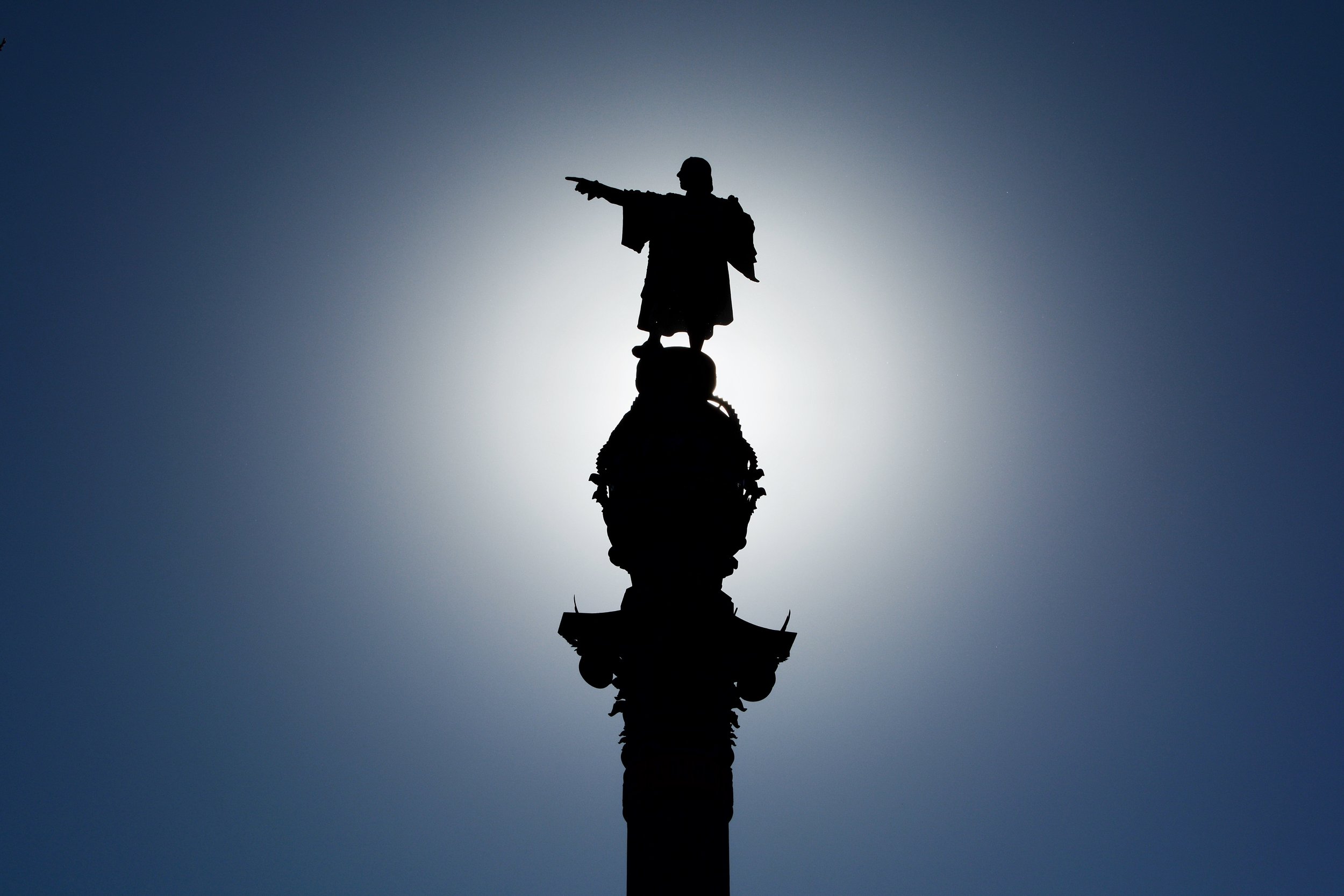  `The  Columbus Monument  is a 60&nbsp;m (197&nbsp;ft) tall monument to Christopher Columbus at the lower end of La Rambla, Barcelona, Catalonia, Spain. It was constructed for the Exposición Universal de Barcelona (1888) in honor of Columbus' first voyage to the Americas. The monument serves as a reminder that Christopher Columbus reported to Queen Isabella I and King Ferdinand V in Barcelona after his first trip to the new continent  Source:  https://en.wikipedia.org/wiki/Columbus_Monument,_Barcelona  