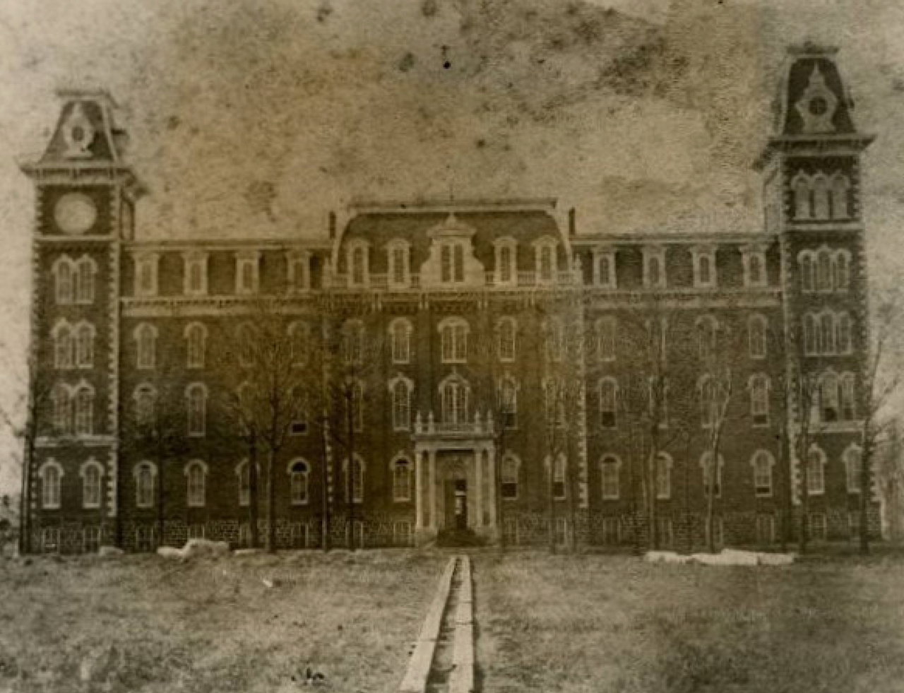  Old Main during or shortly after construction.  Note the timber rails leading to Old Main that were used to move timber during construction. 